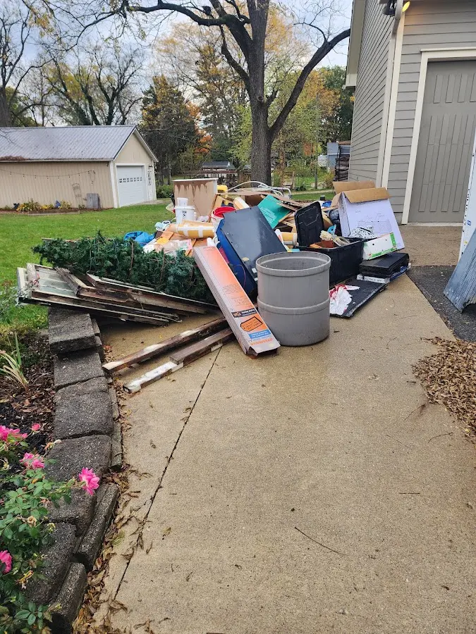 Dumpster being loaded with debris for Estate Cleanout Dumpster Rental in Mount Hope